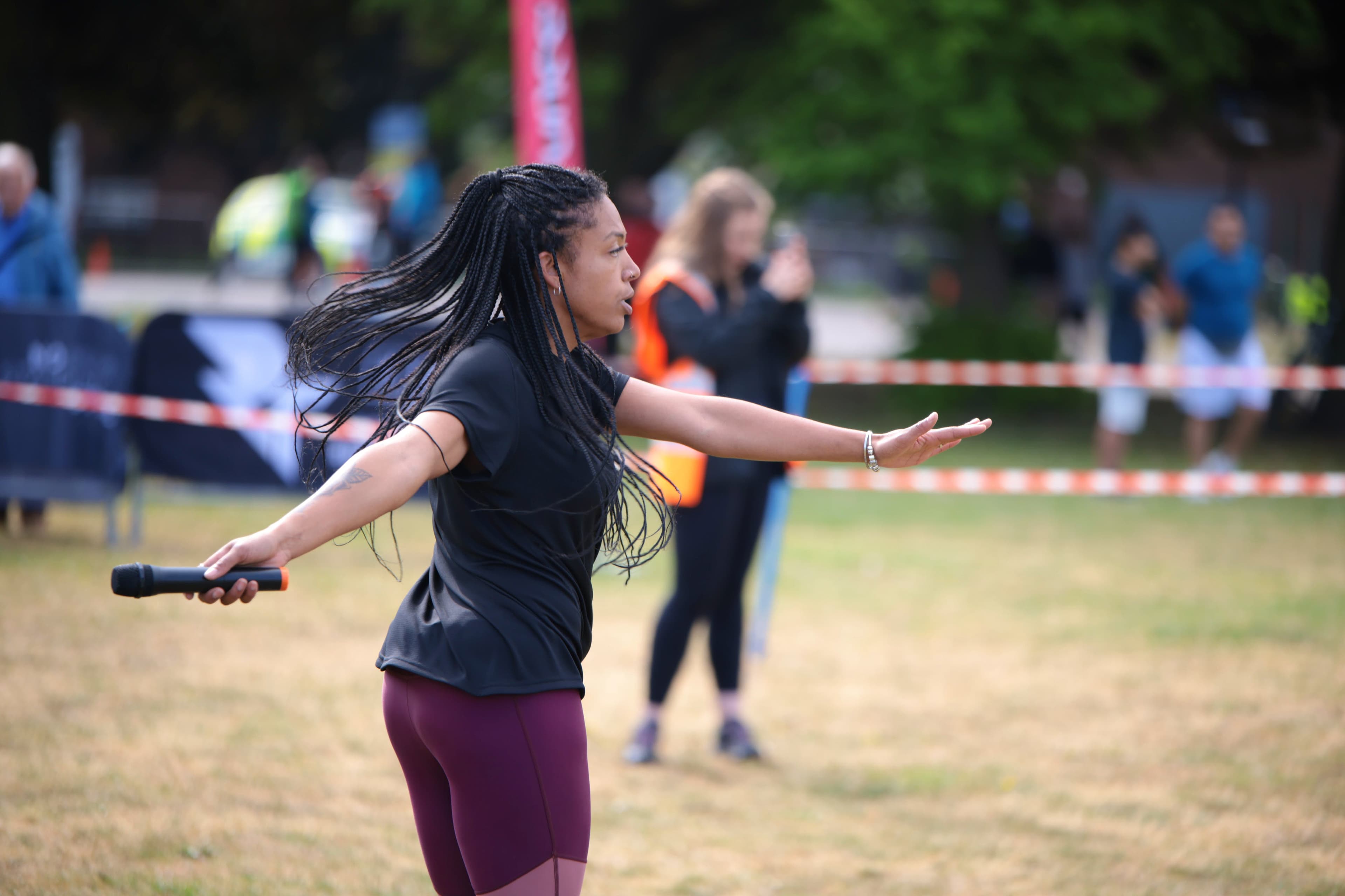 A RunThrough presenter leading the warm-up with a course marshal in hi-vis behind